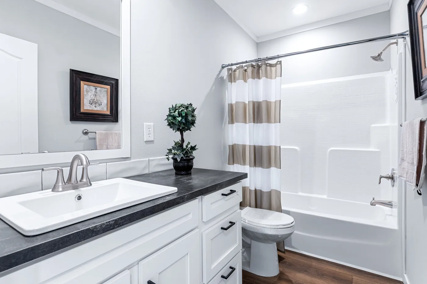 The THE FUJI Guest Bathroom. This Manufactured Mobile Home features 4 bedrooms and 3 baths.