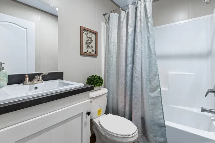 The RESOLUTION 16763X Guest Bathroom. This Manufactured Mobile Home features 3 bedrooms and 2 baths.