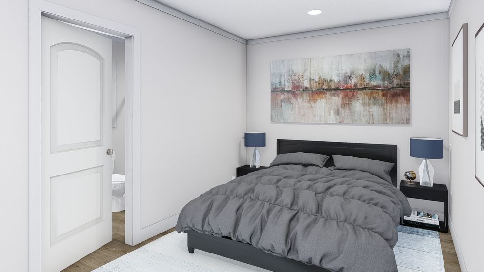 The STILL THE ONE Primary Bedroom. This Manufactured Mobile Home features 2 bedrooms and 2 baths.