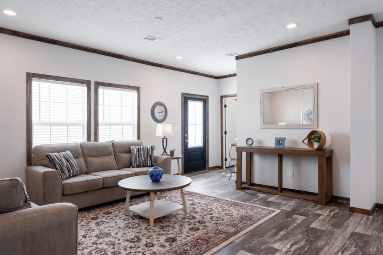 The 3237 THE TYBEE HUD Living Room. This Manufactured Mobile Home features 4 bedrooms and 3 baths.