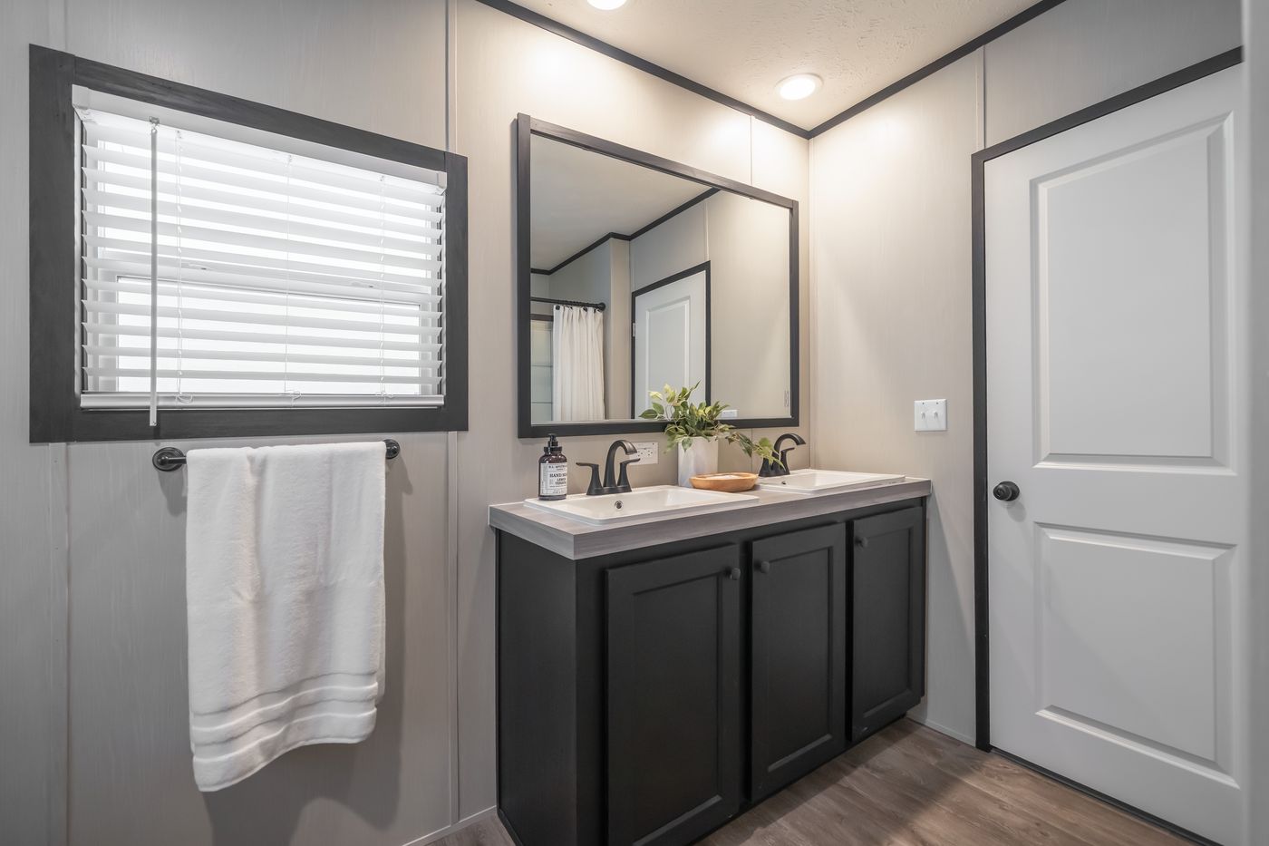 The CRAZY EIGHTS Primary Bathroom. This Manufactured Mobile Home features 4 bedrooms and 2 baths.