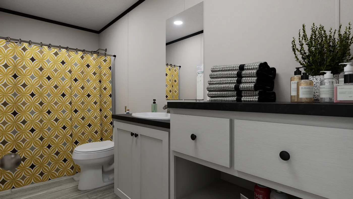 The THE MOUNTAINEER 56 Guest Bathroom. This Manufactured Mobile Home features 3 bedrooms and 2 baths.