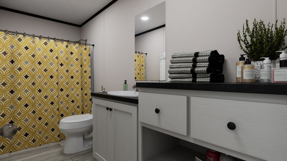 The THE MOUNTAINEER 56 Guest Bathroom. This Manufactured Mobile Home features 3 bedrooms and 2 baths.