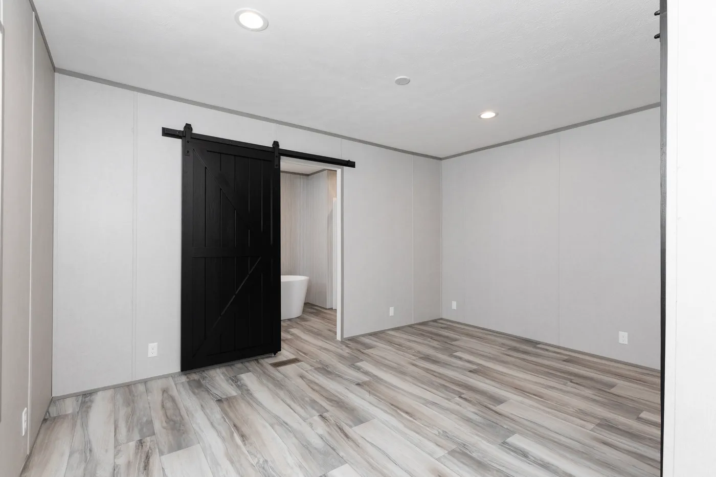 The THE OLYMPUS Primary Bedroom. This Manufactured Mobile Home features 3 bedrooms and 2 baths.