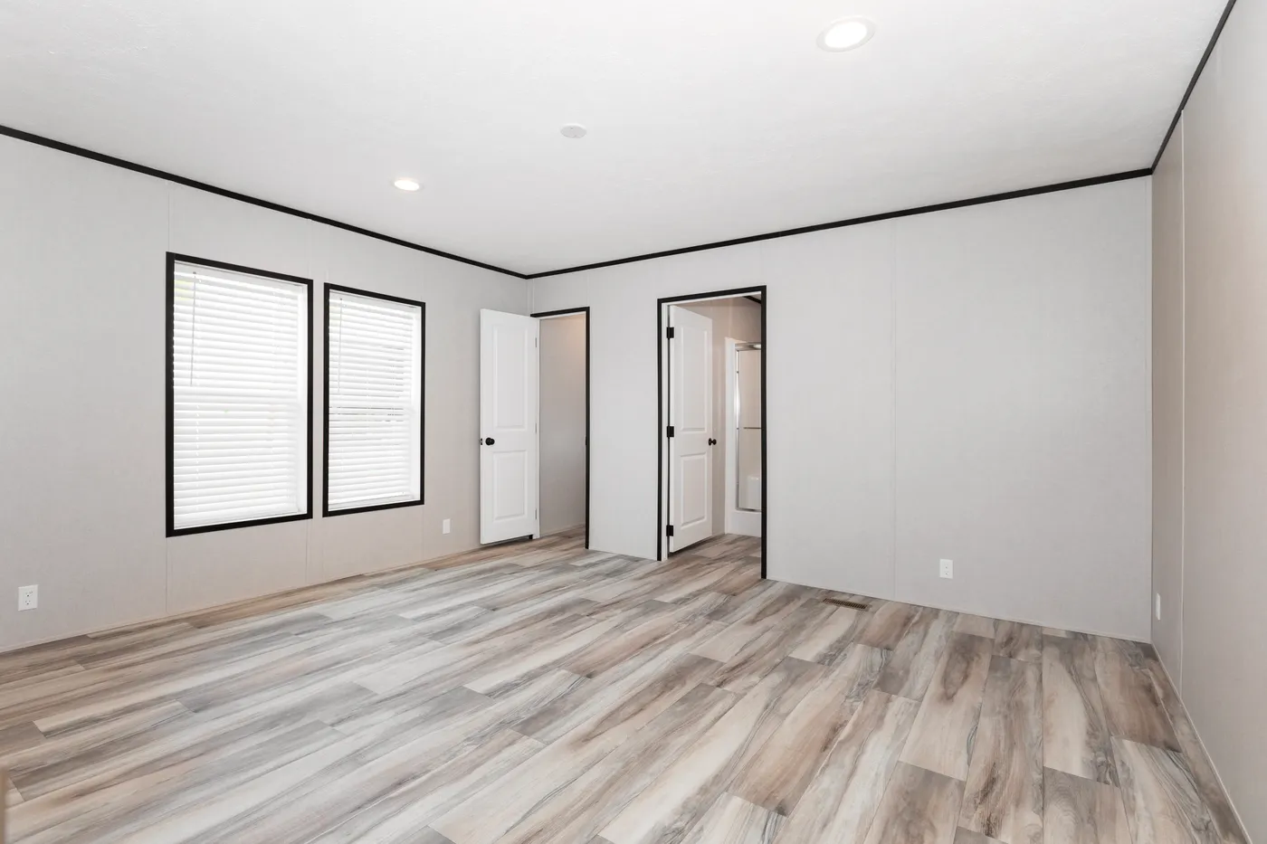 The THE FUJI Primary Bedroom. This Manufactured Mobile Home features 3 bedrooms and 2 baths.