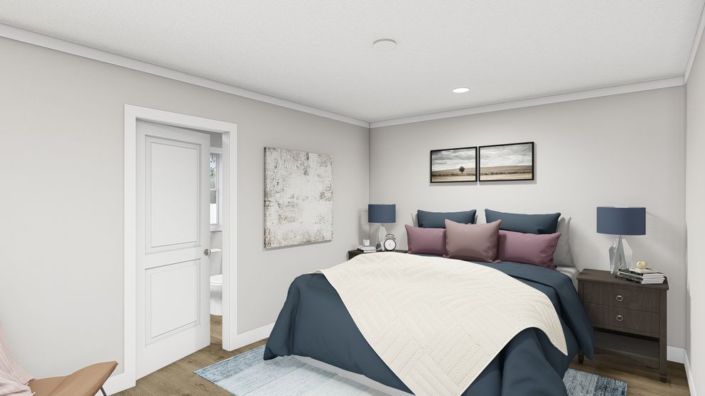 The MOVE ON UP Primary Bedroom. This Manufactured Mobile Home features 3 bedrooms and 2 baths.