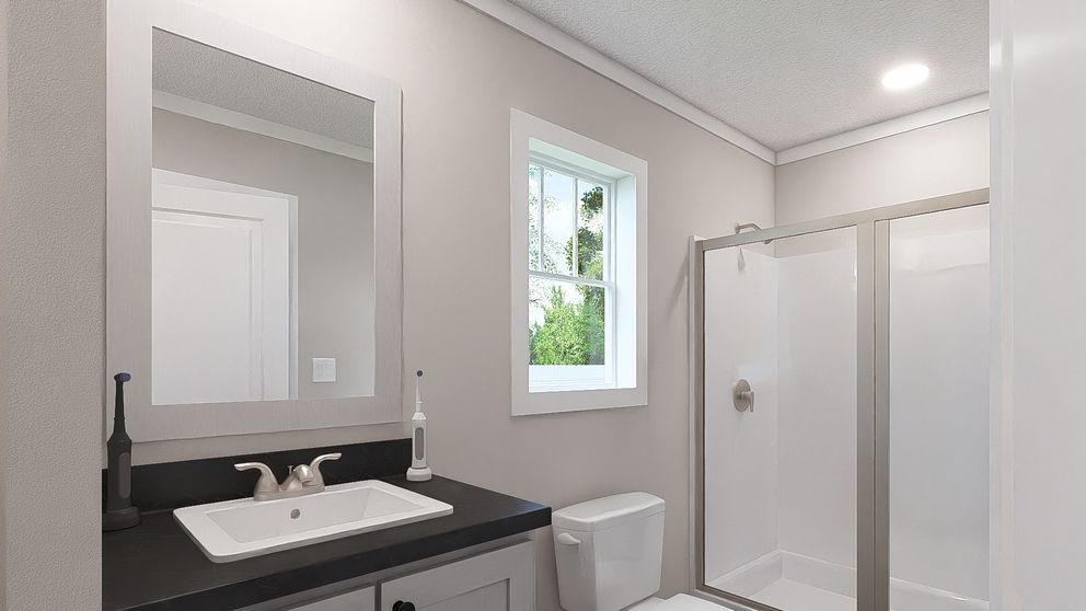 The STILL THE ONE Primary Bathroom. This Manufactured Mobile Home features 2 bedrooms and 2 baths.