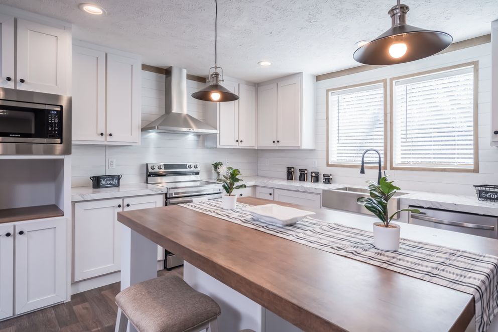 The FARMHOUSE BREEZE 72 Kitchen. This Manufactured Mobile Home features 4 bedrooms and 2 baths.