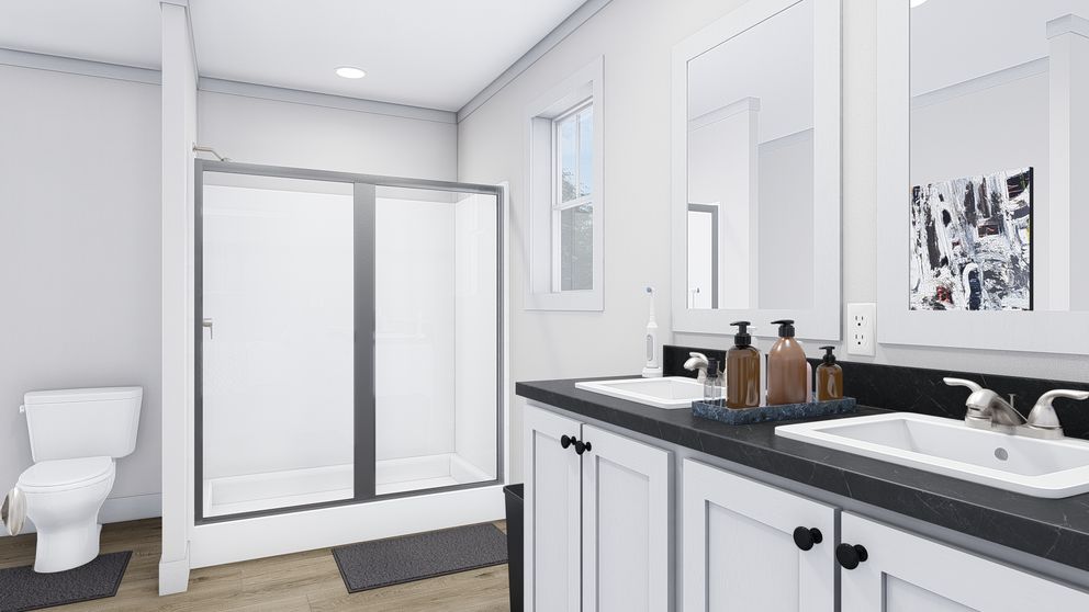 The STAYIN' ALIVE Primary Bathroom. This Manufactured Mobile Home features 3 bedrooms and 2 baths.