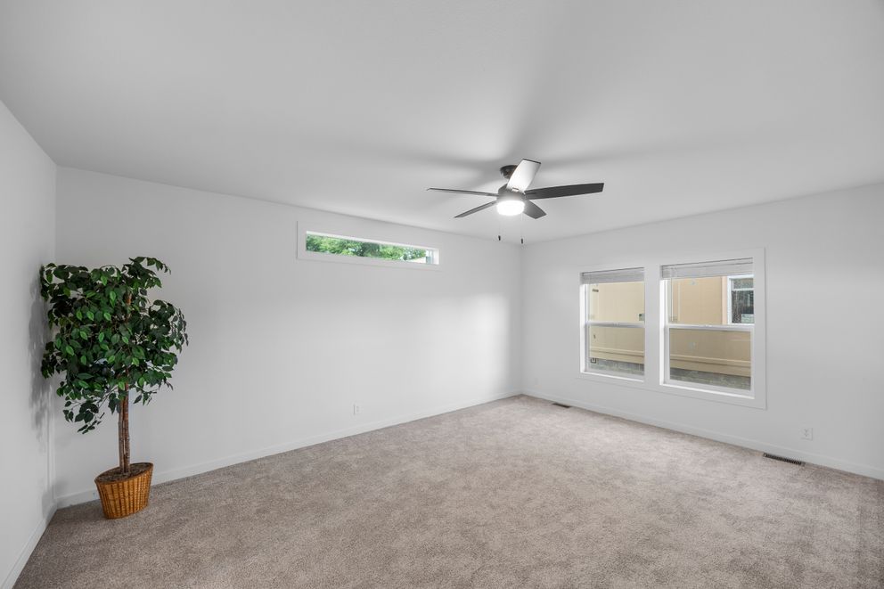 The LULAMAE 3 Primary Bedroom. This Manufactured Mobile Home features 3 bedrooms and 2 baths.