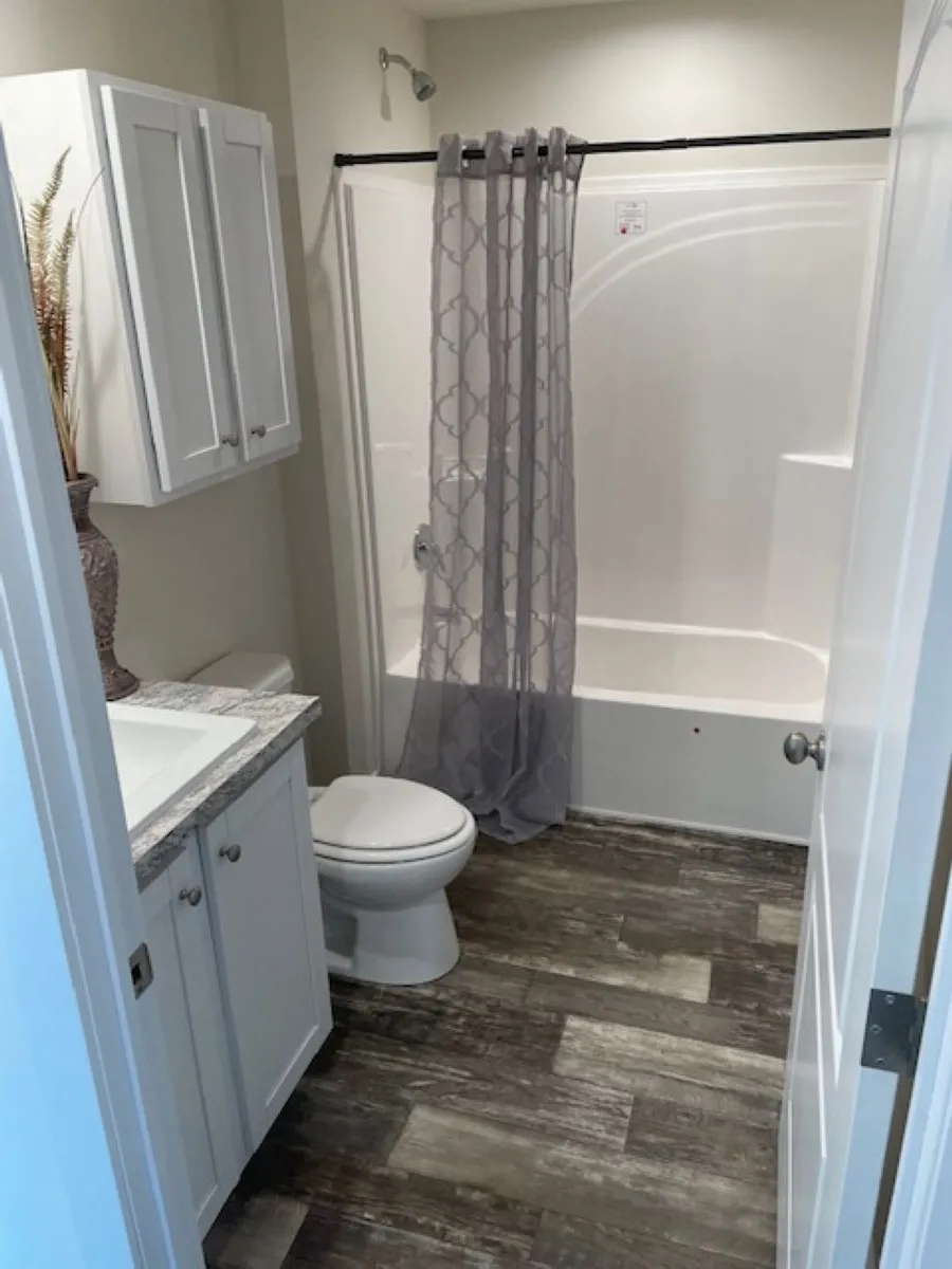 The SUNLIGHT/5628-MS054 SECT Primary Bedroom. This Manufactured Mobile Home features 3 bedrooms and 2 baths.