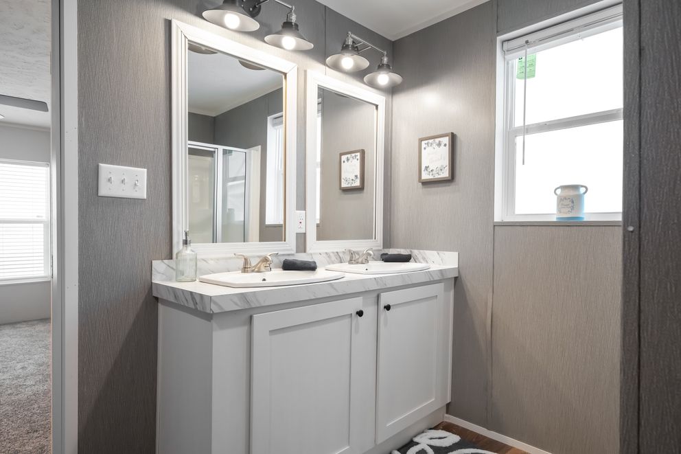 The TRADITION 3268B Primary Bathroom. This Manufactured Mobile Home features 5 bedrooms and 3 baths.