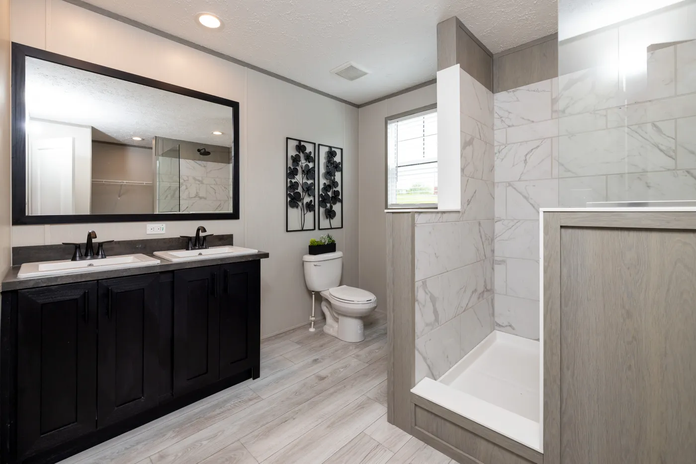The SHOWER HOUSE Primary Bathroom. This Manufactured Mobile Home features 3 bedrooms and 2 baths.