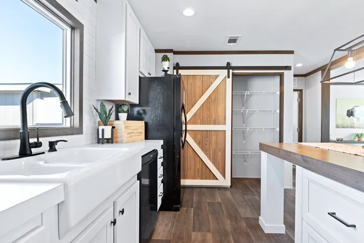 The BREEZE FARMHOUSE Kitchen. This Manufactured Mobile Home features 3 bedrooms and 2 baths.