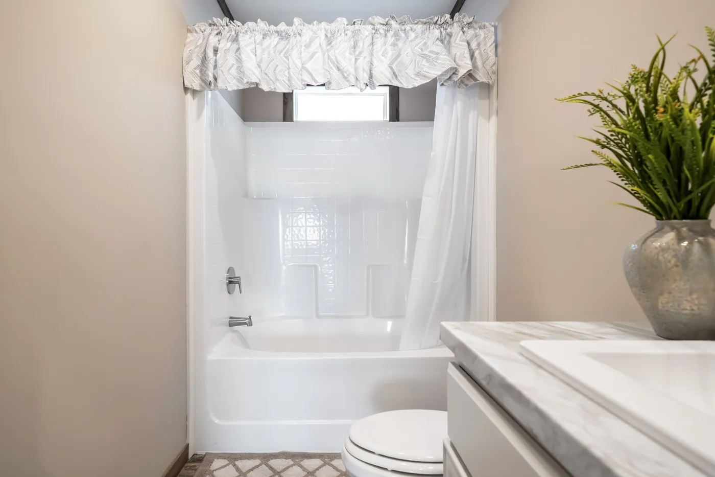 The THE TYRA Guest Bathroom. This Manufactured Mobile Home features 4 bedrooms and 2 baths.