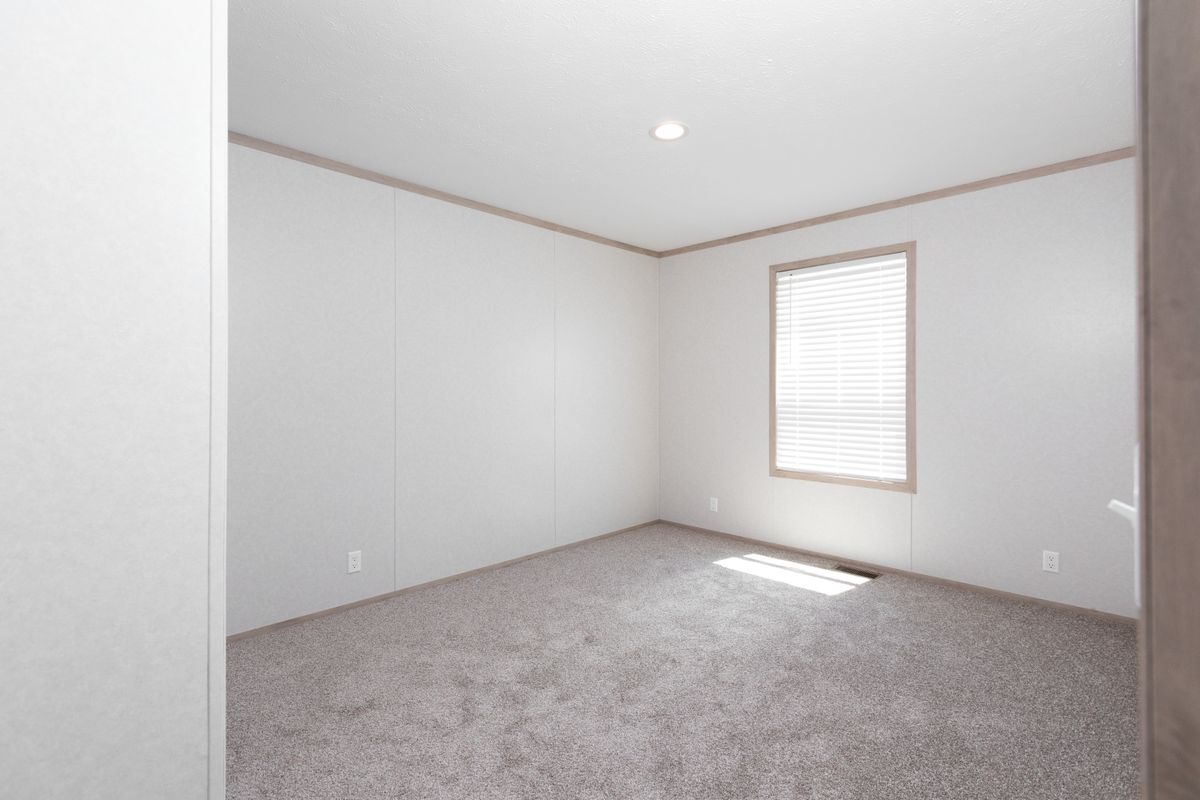 The 6032-5700 THE PULSE Guest Bedroom. This Manufactured Mobile Home features 3 bedrooms and 2 baths.