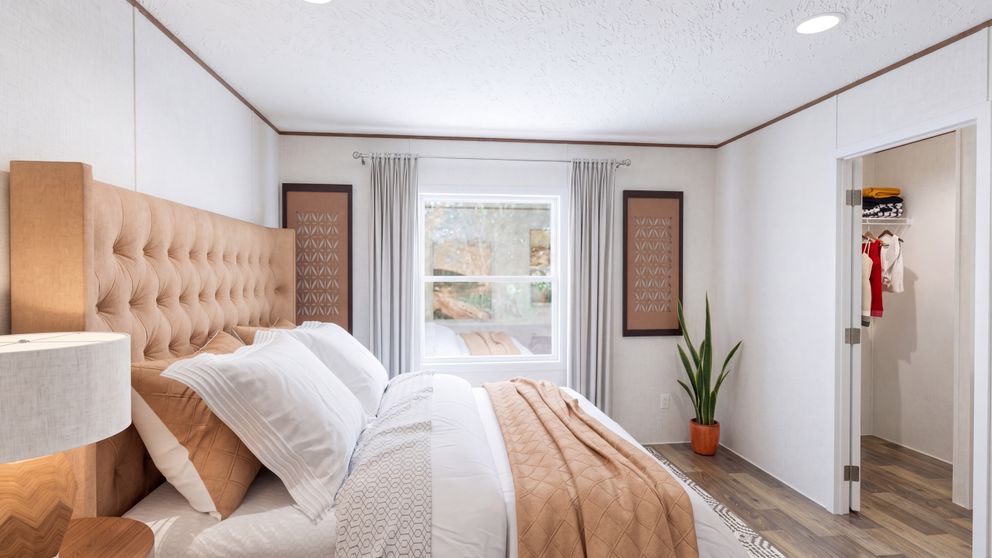 The HICKORY Primary Bedroom. This Manufactured Mobile Home features 3 bedrooms and 2 baths.