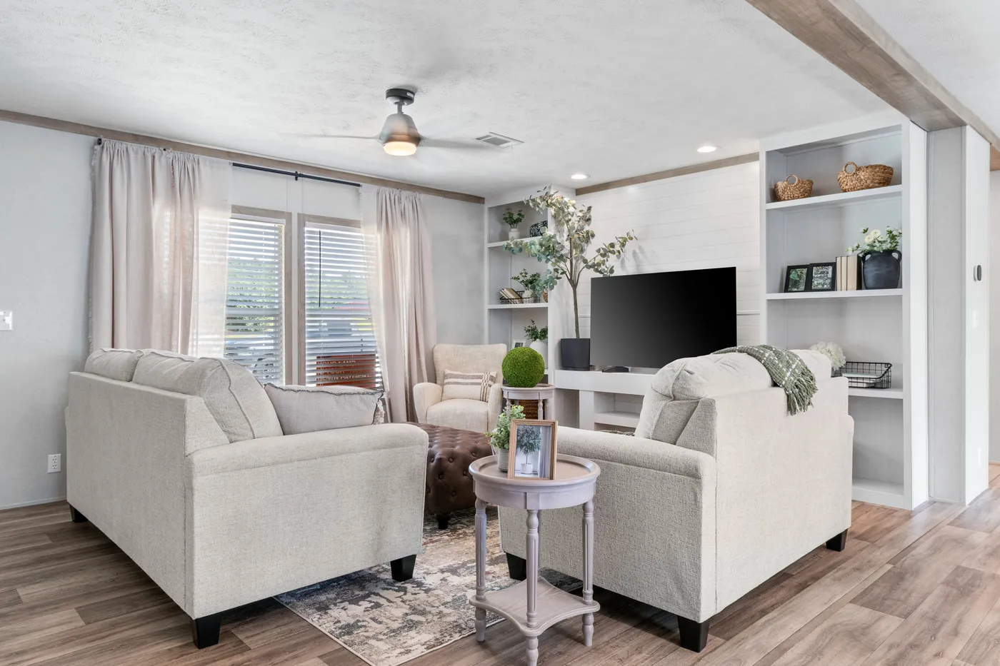 The THE REAL DEAL Living Room. This Manufactured Mobile Home features 3 bedrooms and 2 baths.