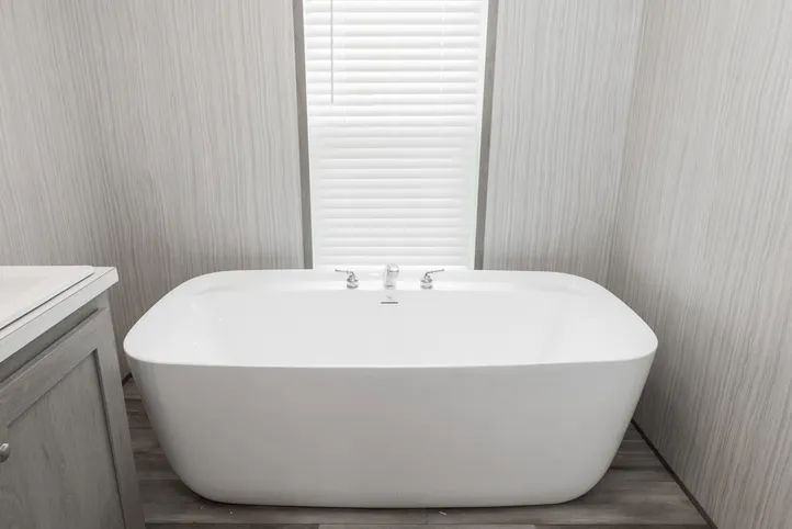 The THE POWERHOUSE Primary Bathroom. This Manufactured Mobile Home features 3 bedrooms and 2 baths.