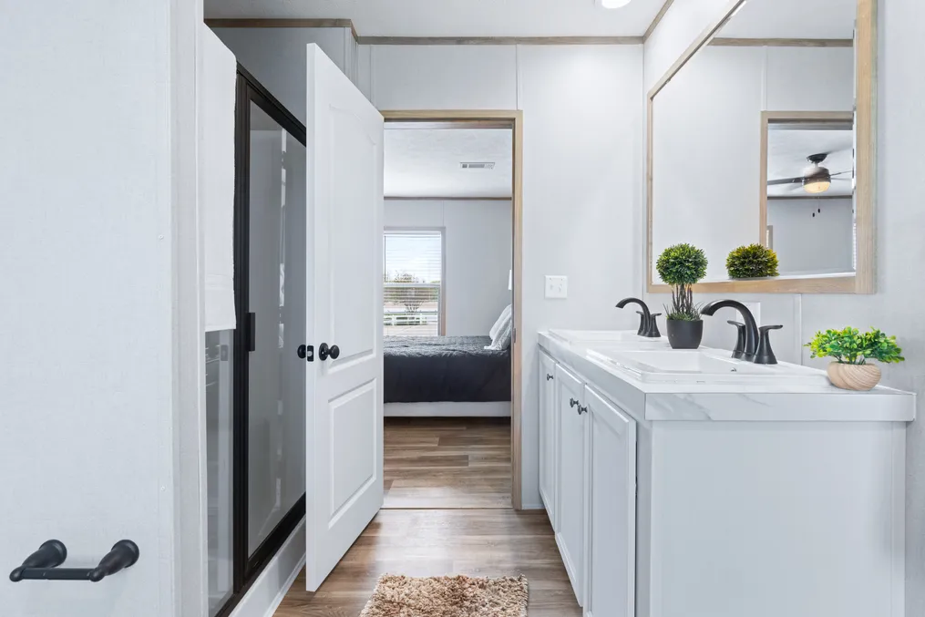 The EL SUENO BREEZE Primary Bathroom. This Manufactured Mobile Home features 4 bedrooms and 2 baths.