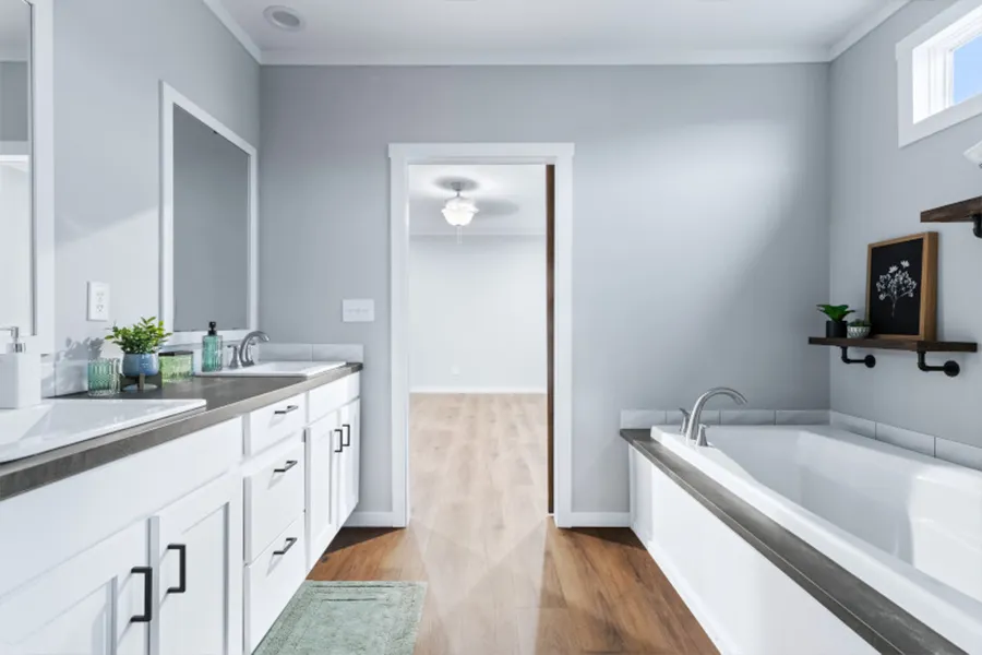 The THE OLYMPUS Primary Bathroom. This Manufactured Mobile Home features 4 bedrooms and 3 baths.