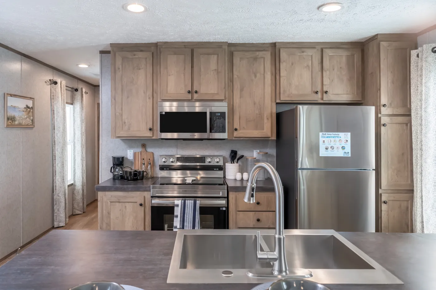 The WARRIOR II Kitchen. This Manufactured Mobile Home features 2 bedrooms and 2 baths.