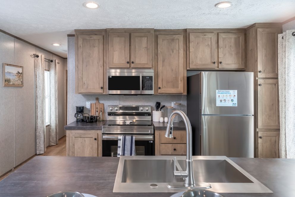 The WARRIOR II Kitchen. This Manufactured Mobile Home features 2 bedrooms and 2 baths.