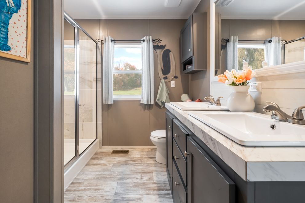 The THE DRIFTWOOD Primary Bathroom. This Manufactured Mobile Home features 3 bedrooms and 2 baths.