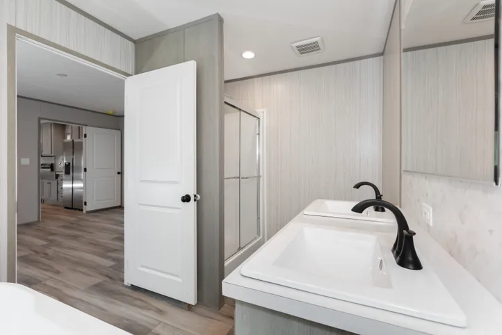 The THE ANNIVERSARY 76 Primary Bathroom. This Manufactured Mobile Home features 3 bedrooms and 2 baths.