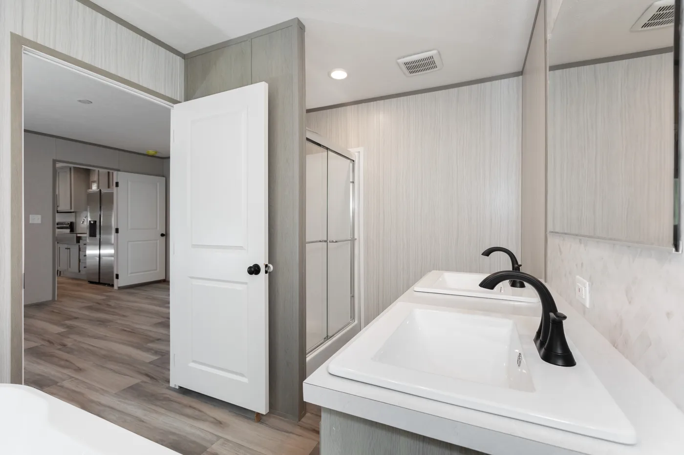 The THE ANNIVERSARY 76 Primary Bathroom. This Manufactured Mobile Home features 3 bedrooms and 2 baths.