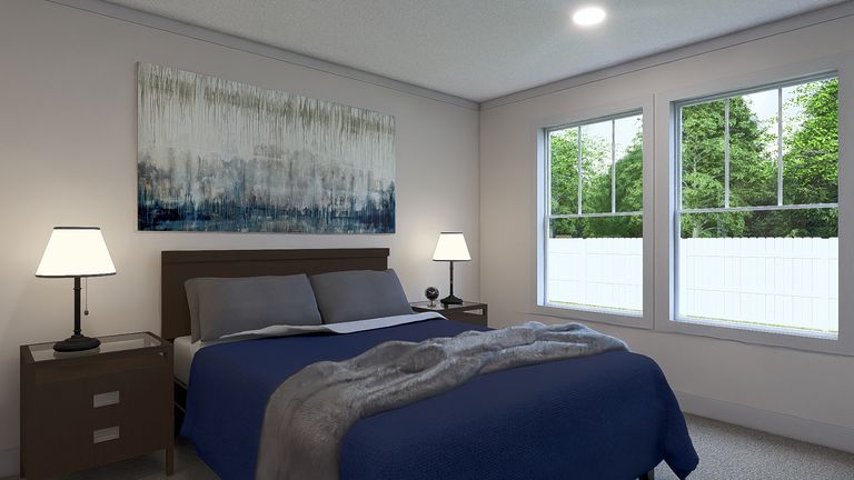 The JOHNNY B GOODE Primary Bedroom. This Manufactured Mobile Home features 3 bedrooms and 2 baths.