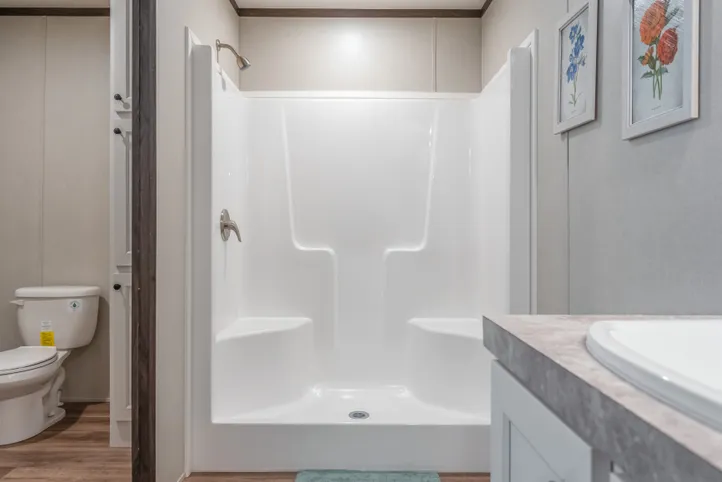 The EMPOWER Primary Bathroom. This Manufactured Mobile Home features 4 bedrooms and 2 baths.
