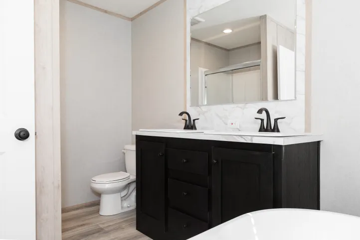 The THE ANNIVERSARY ISLANDER Primary Bathroom. This Manufactured Mobile Home features 3 bedrooms and 2 baths.