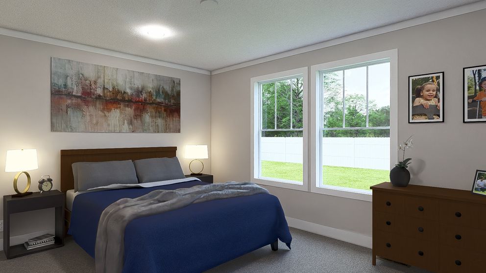 The THREE LITTLE BIRDS Primary Bedroom. This Manufactured Mobile Home features 3 bedrooms and 2 baths.