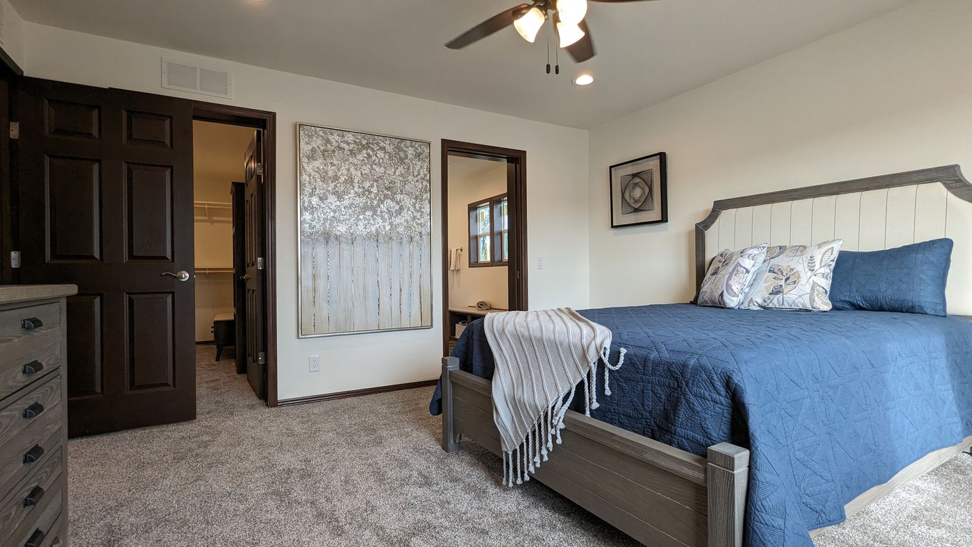 The LEGEND 327-1 Primary Bedroom. This Manufactured Mobile Home features 3 bedrooms and 2 baths.