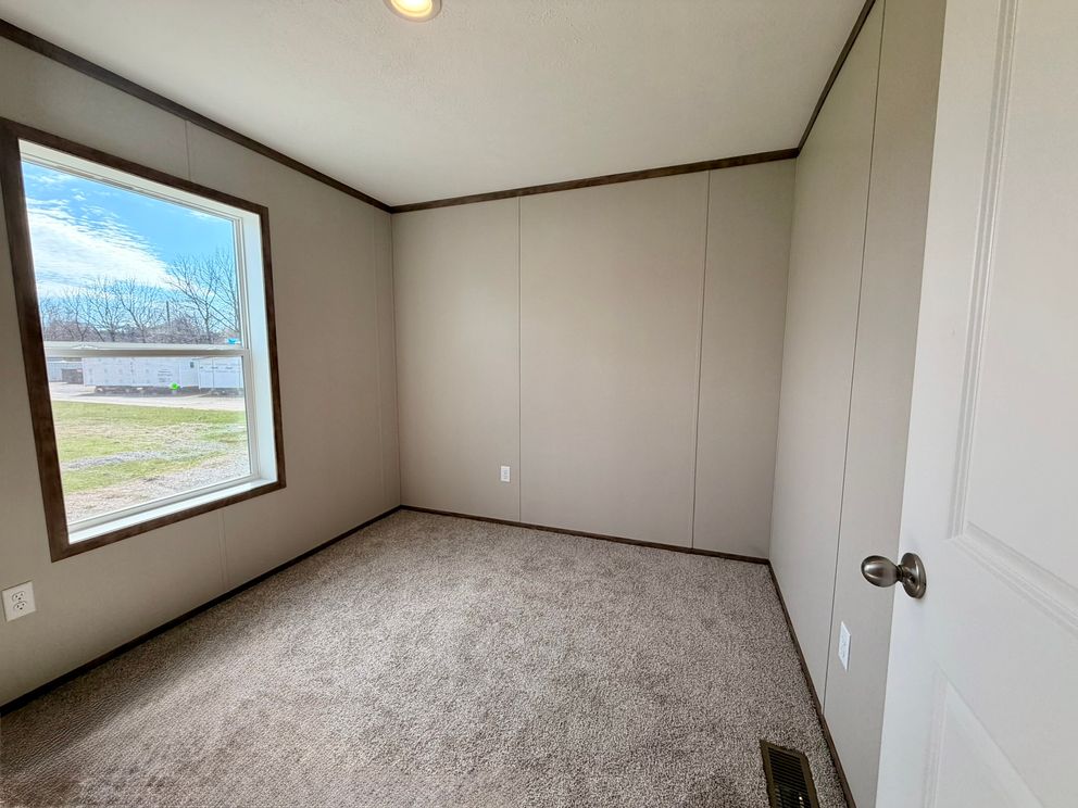 The APATITE Guest Bedroom. This Manufactured Mobile Home features 3 bedrooms and 2 baths.