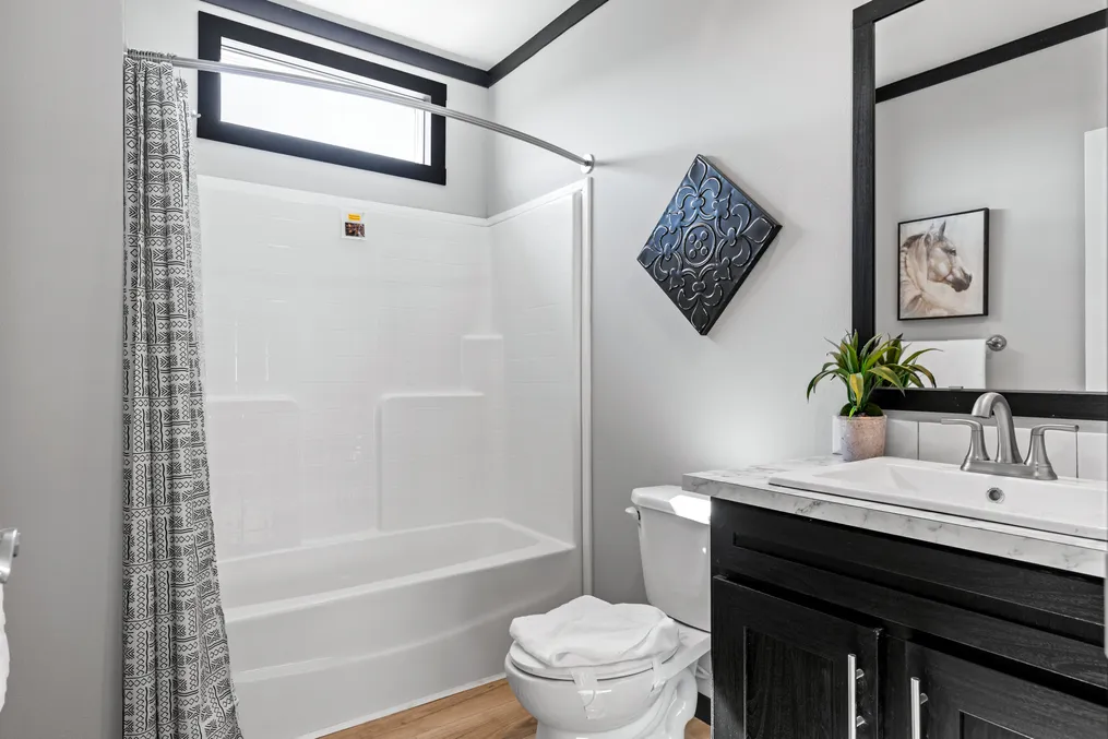 The THE MAUI Guest Bathroom. This Manufactured Mobile Home features 3 bedrooms and 2 baths.