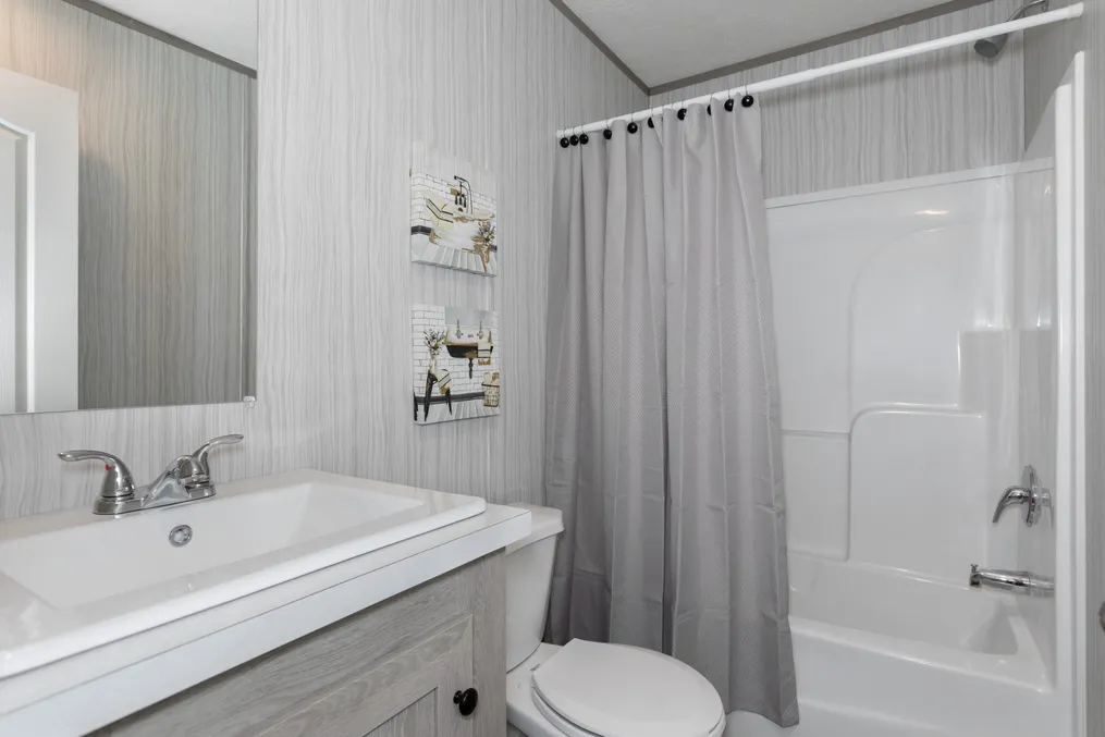 The THE ANNIVERSARY 76 Guest Bathroom. This Manufactured Mobile Home features 3 bedrooms and 2 baths.