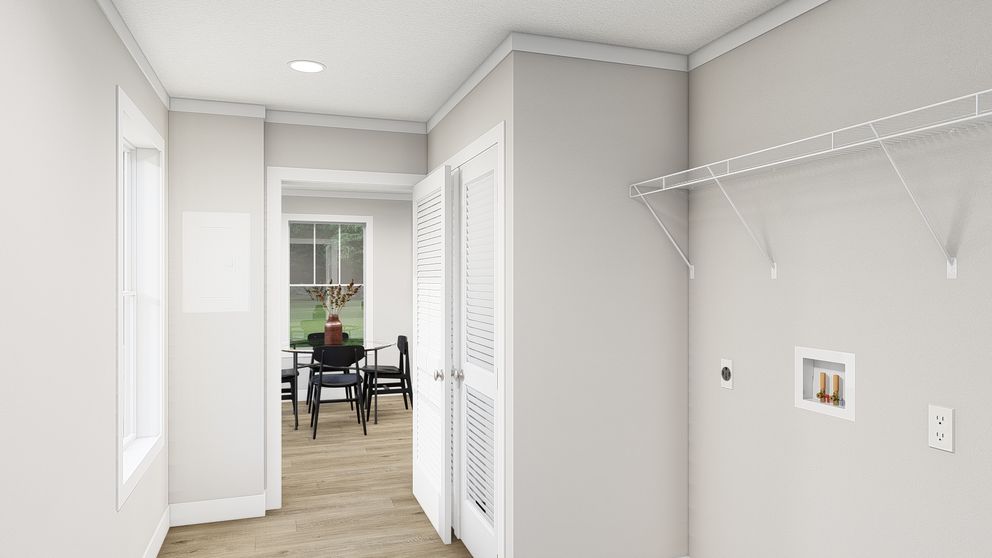 The HERE COMES THE SUN Utility Room. This Manufactured Mobile Home features 3 bedrooms and 2 baths.