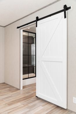 The PLATINUM ANNIVERSARY Primary Bedroom. This Manufactured Mobile Home features 3 bedrooms and 2 baths.