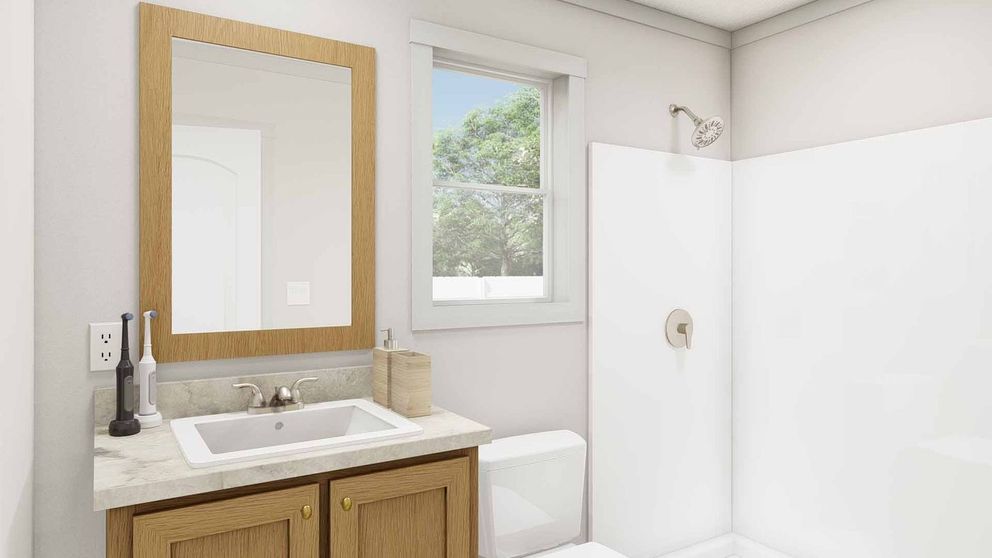 The GOOD VIBRATIONS Primary Bathroom. This Manufactured Mobile Home features 3 bedrooms and 2 baths.