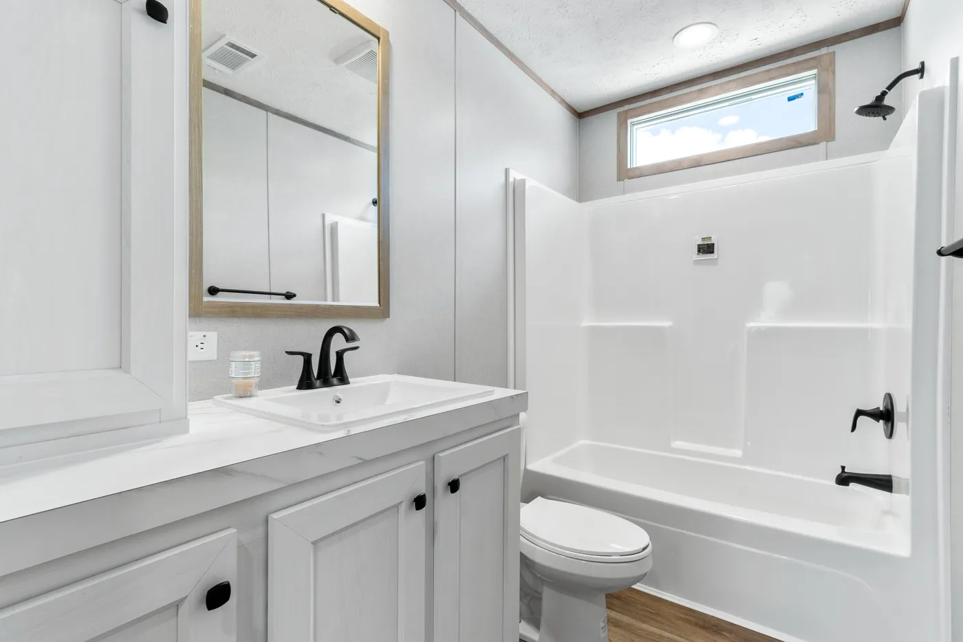 The THE REAL DEAL Guest Bathroom. This Manufactured Mobile Home features 3 bedrooms and 2 baths.