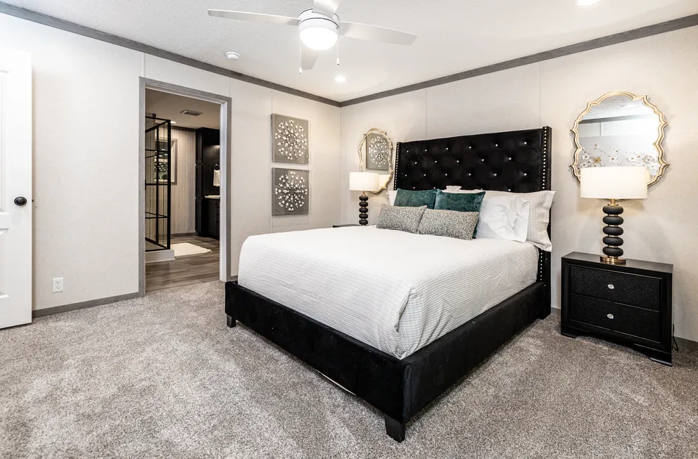 The 6428-E792 THE PULSE Primary Bedroom. This Manufactured Mobile Home features 3 bedrooms and 2.5 baths.