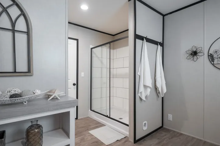 The BREEZE FARMHOUSE Primary Bathroom. This Manufactured Mobile Home features 3 bedrooms and 2 baths.