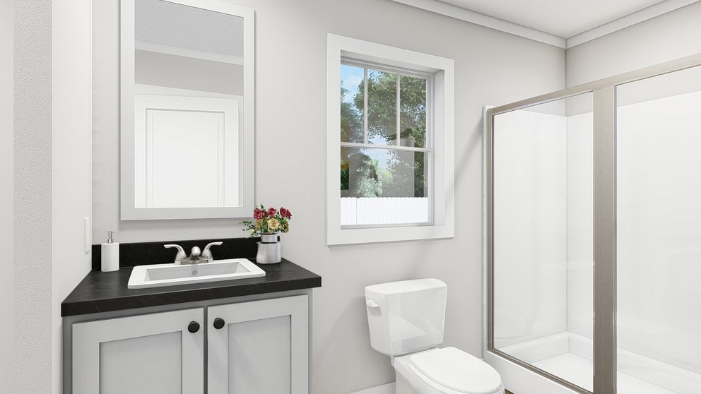 The MOVE ON UP Primary Bathroom. This Manufactured Mobile Home features 3 bedrooms and 2 baths.