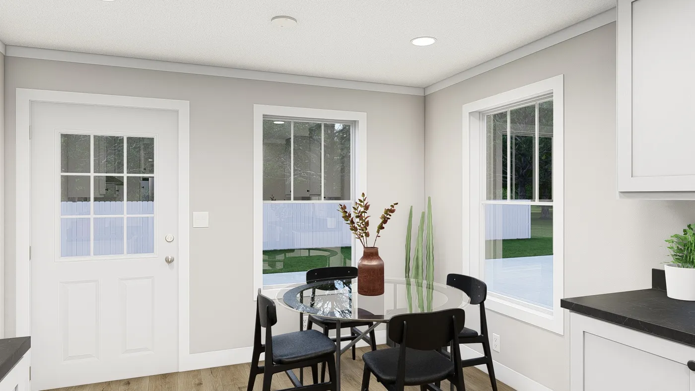 The HERE COMES THE SUN Dining Area. This Manufactured Mobile Home features 3 bedrooms and 2 baths.