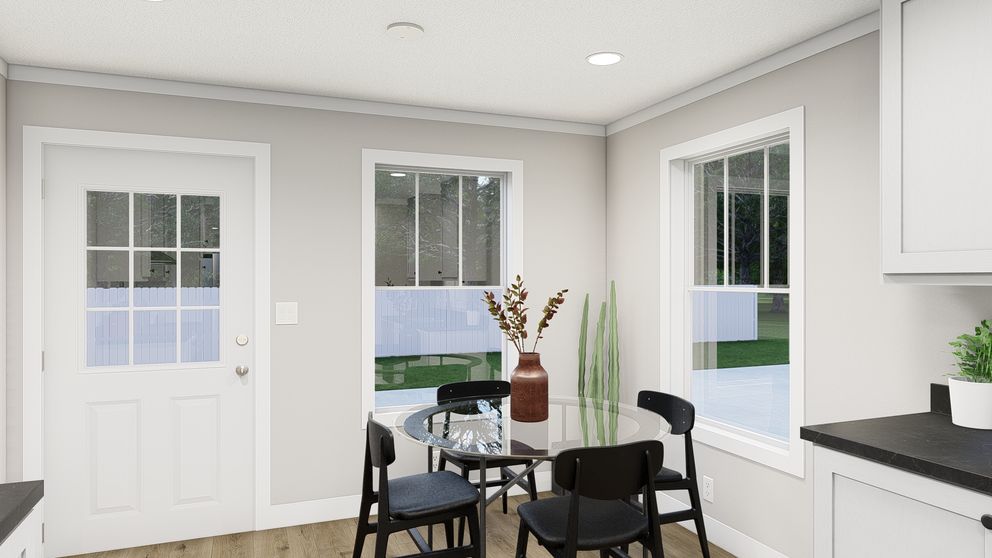 The HERE COMES THE SUN Dining Area. This Manufactured Mobile Home features 3 bedrooms and 2 baths.