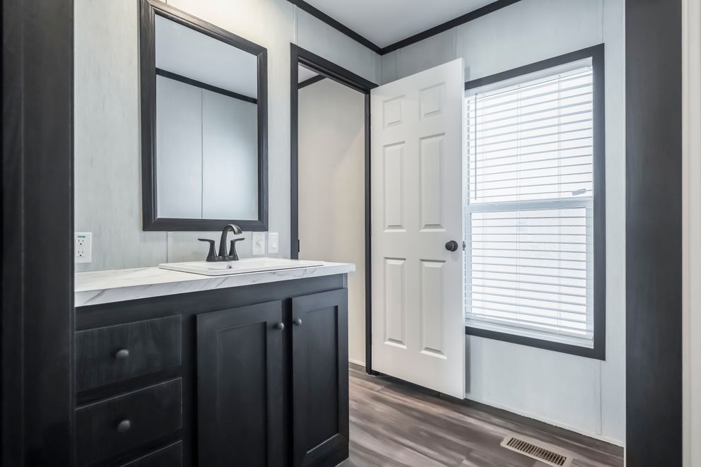 The LIL SOUTHERN CHARM Primary Bathroom. This Manufactured Mobile Home features 3 bedrooms and 2 baths.