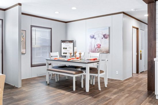 The BREEZE FARMHOUSE 72 Dining Area. This Manufactured Mobile Home features 4 bedrooms and 2 baths.