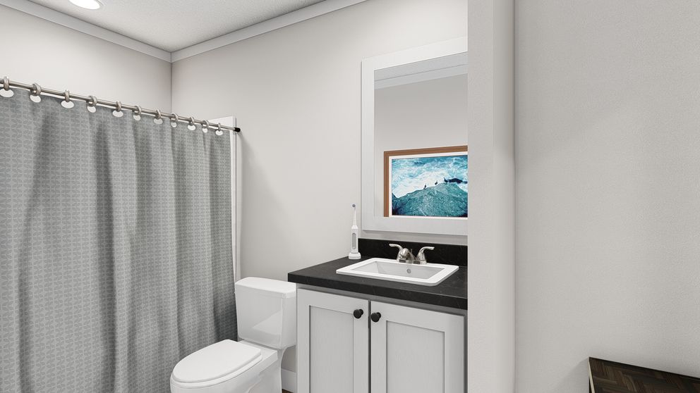 The THREE LITTLE BIRDS Guest Bathroom. This Manufactured Mobile Home features 3 bedrooms and 2 baths.